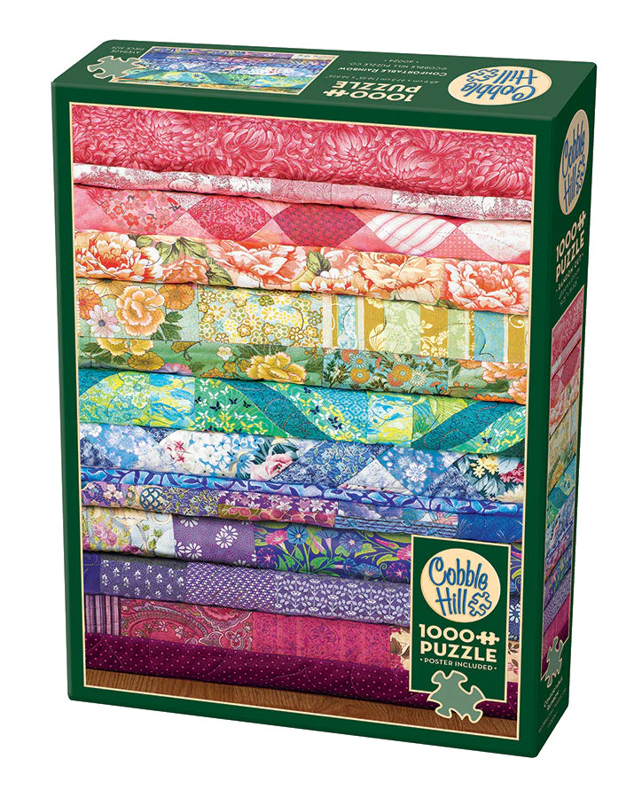 Cobble Hill 1000 Piece puzzle, poster included. Box shows image of quilts stacked and folded in a rainbow of colors with different fabric patterns.