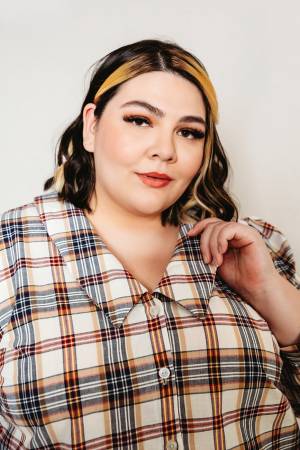 The Patina Blouse is a collared, v-neck, button up top. The sleeves are full and the pattern includes options for a short sleeve or long sleeve