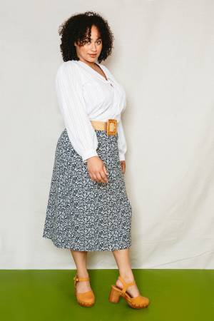 The Patina Blouse is a collared, v-neck, button up top. The sleeves are full and the pattern includes options for a short sleeve or long sleeve