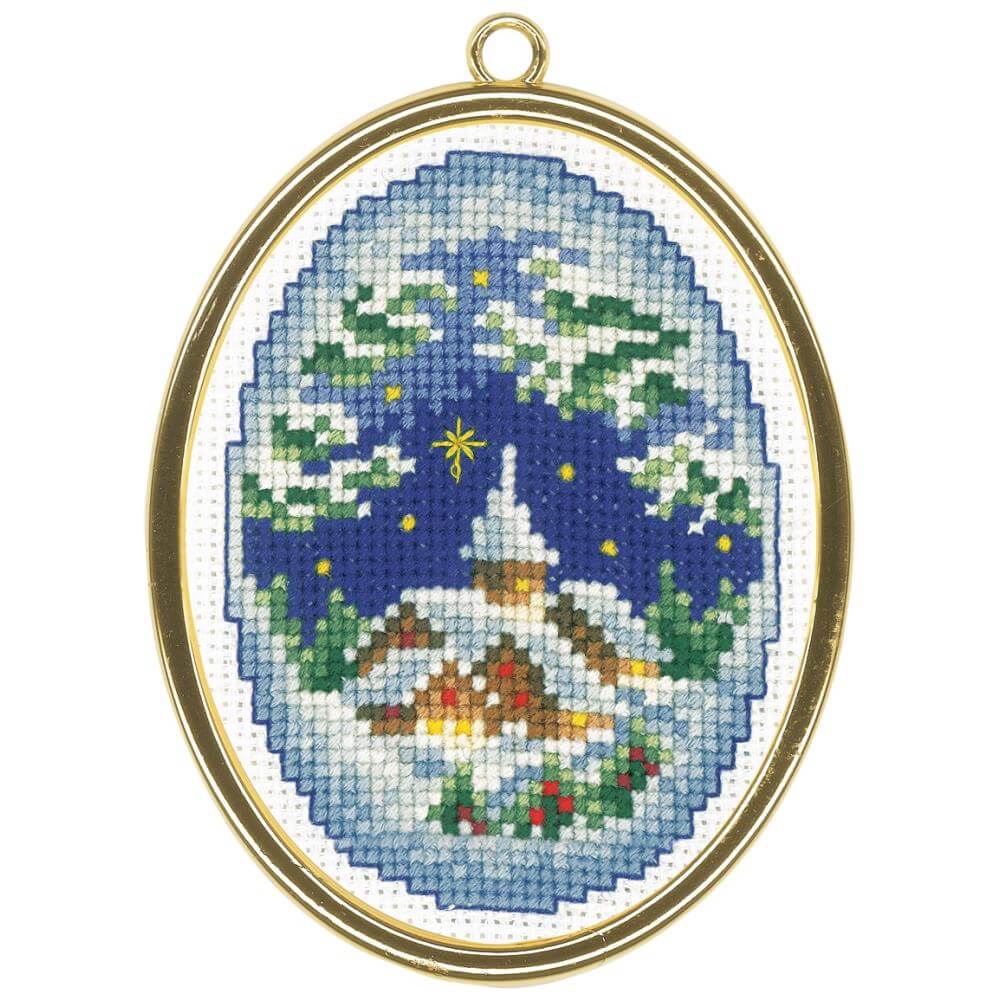 Oval winter village scene ornament