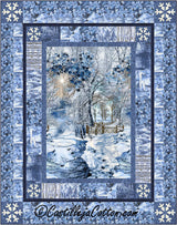 Quilt with a winter scene featuring trees and a fence, framed by snowflakes and blue patterns.