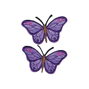Iridescent purple butterfly iron-on appliques, two of them with pink accents. and brown bodies