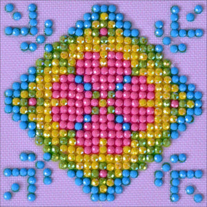 Diamond Dotz rainbow Patchwork Mandala kit end result featuring pink, yellow, green and blue on a light purple background