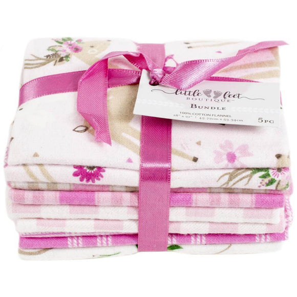 Wild & Free fat quarter fabric bundle with five fabrics, tied up in pink ribbon with a tag from Little Feet Boutique. Top fabric shows a deer and flowers.