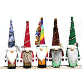 Gnome bottle topper examples - they fit over wine bottles. Shown in blue, red, rainbow, brown, and green