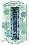 Welcome to Our Home quilt pattern that shows the word home and has snow flakes on it.