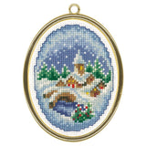 Winter village ornament in oval frame